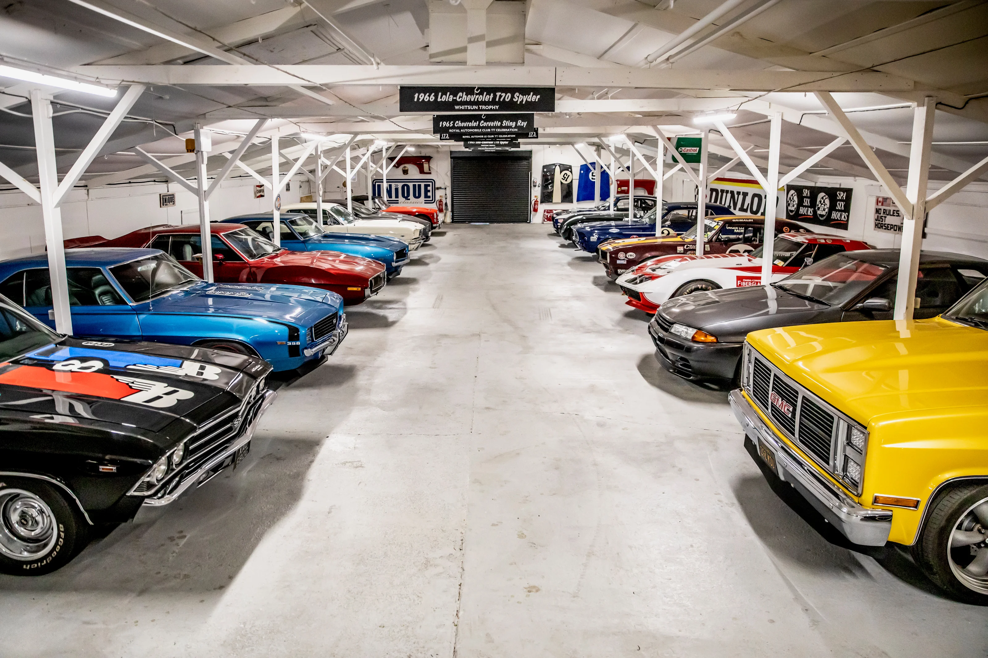 Classic cars lined up on both sides of the collection room