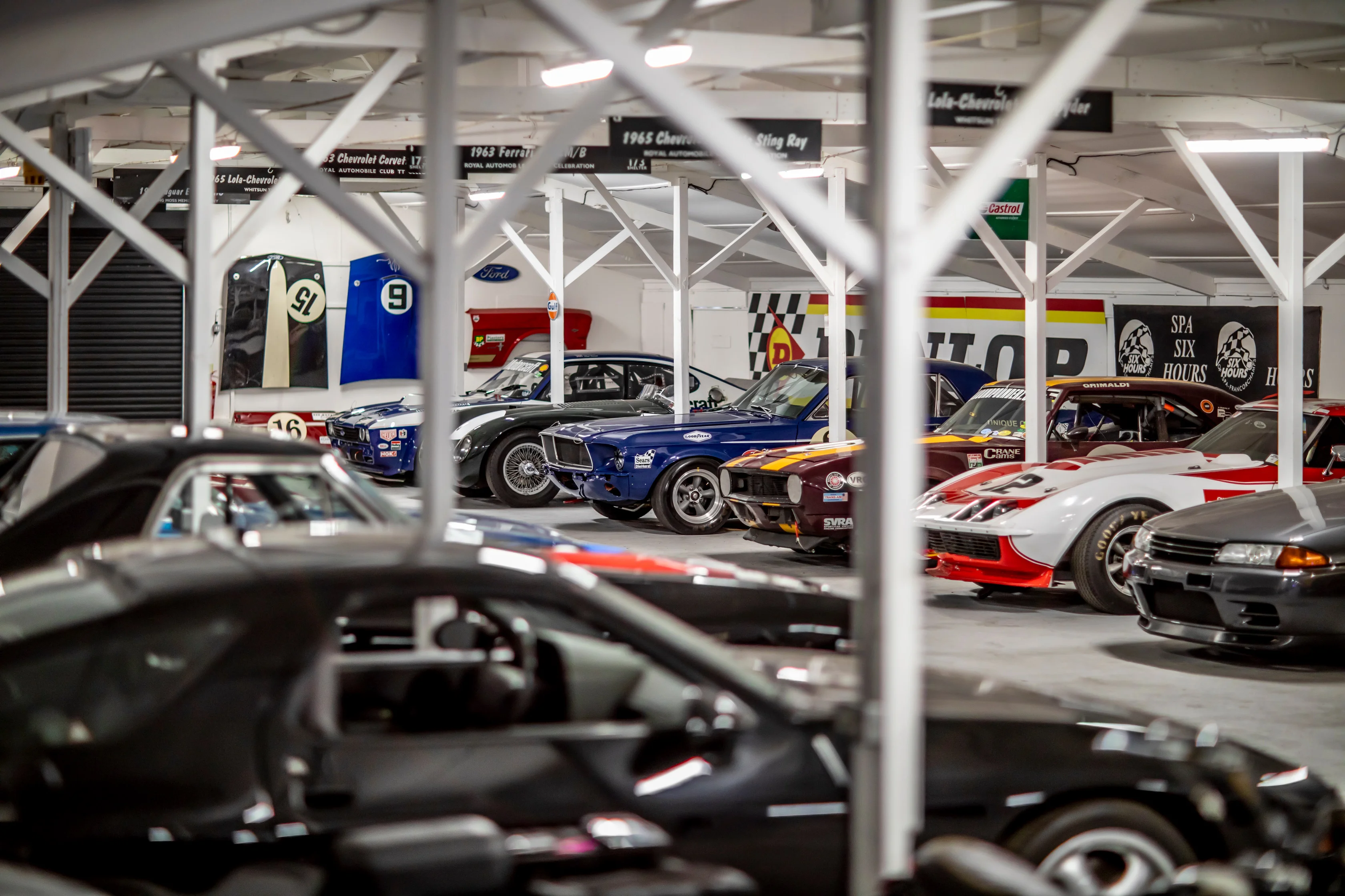Classic cars in the Paddock Club collection viewed through the workshop