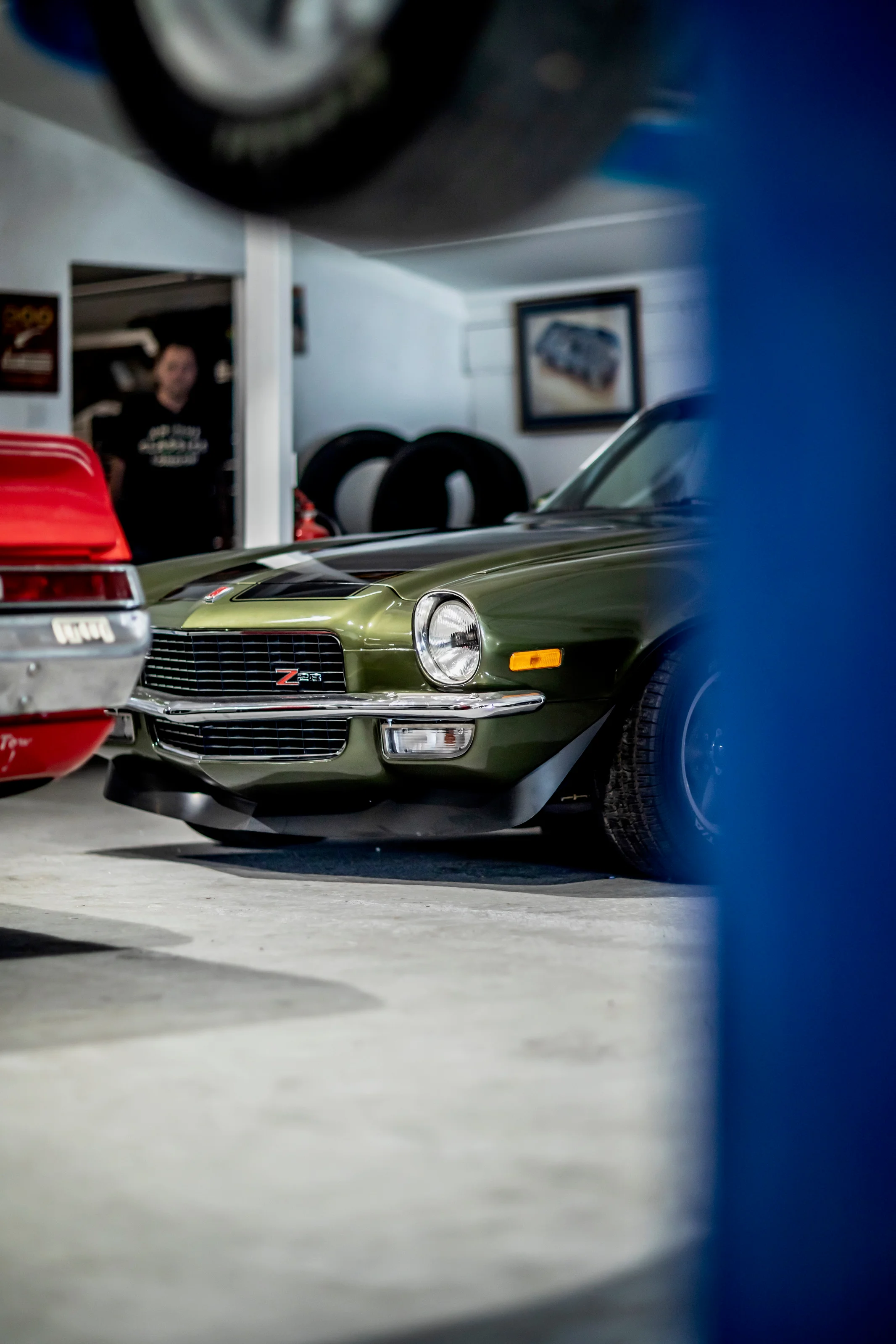 Green classic Camaro inside the Paddock Club workshop