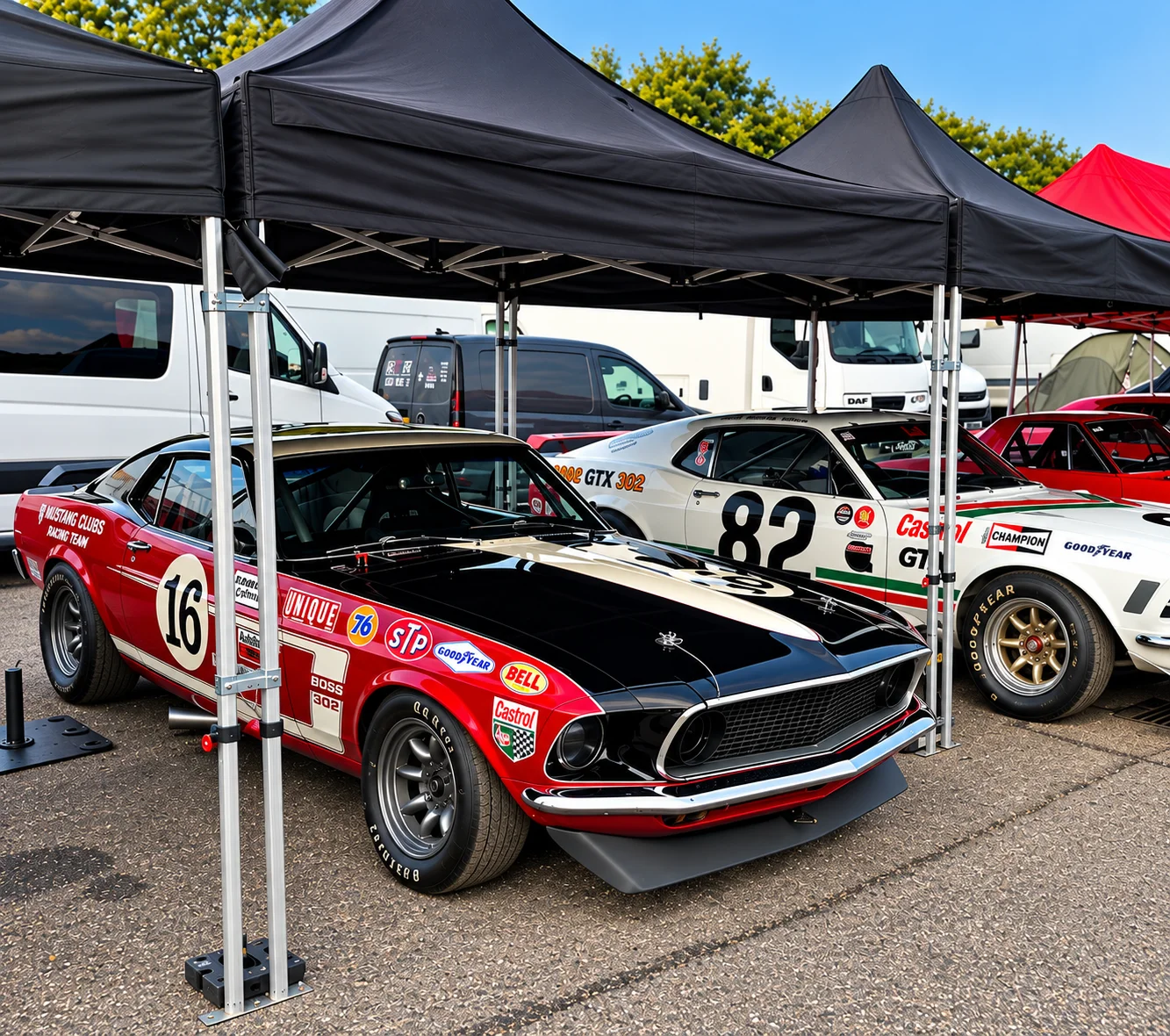 Two classic race cars together in the paddock
