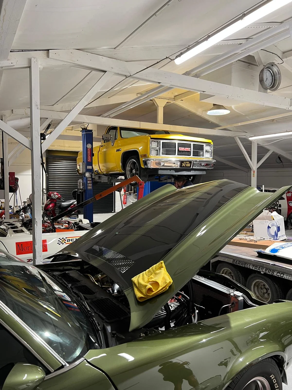 Classic American cars being prepared inside The Paddock Club workshop